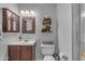 Cozy bathroom with decorative wall art, a brown vanity and a neutral-colored walls at 780 S Lagoon Dr, Gilbert, AZ 85233