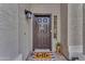 Charming front entrance featuring a decorative door, a 'hello' mat, and accent lighting, creating a warm welcome at 780 S Lagoon Dr, Gilbert, AZ 85233