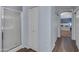 Hallway featuring access to the bathroom with glass-enclosed shower and a bedroom at 780 S Lagoon Dr, Gilbert, AZ 85233