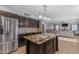 Bright open kitchen with granite countertops, dark brown cabinets, and a stainless steel refrigerator at 780 S Lagoon Dr, Gilbert, AZ 85233
