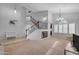 Open-concept living room featuring a staircase, large windows, and a bar area, perfect for entertaining guests at 780 S Lagoon Dr, Gilbert, AZ 85233