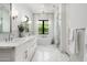 Bright, modern bathroom features double sinks, a soaking tub, and a glass-enclosed shower at 7902 E Via Linda --, Scottsdale, AZ 85258