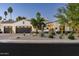 Charming home exterior with a three-car garage, desert landscaping, and a well-maintained lawn at 7902 E Via Linda --, Scottsdale, AZ 85258