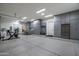 Spacious garage with epoxy flooring, organized storage cabinets, and modern exercise equipment at 7902 E Via Linda --, Scottsdale, AZ 85258