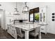 Bright, open kitchen features white cabinets, granite countertops, and a large island with seating at 7902 E Via Linda --, Scottsdale, AZ 85258