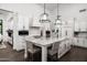 Spacious kitchen with stainless steel appliances, island with seating, and modern lighting at 7902 E Via Linda --, Scottsdale, AZ 85258