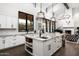 Bright, open kitchen features white cabinets, granite countertops, and a large island with seating at 7902 E Via Linda --, Scottsdale, AZ 85258