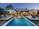 The rear exterior features a pristine pool, covered patio and pristine landscaping at 7902 E Via Linda --, Scottsdale, AZ 85258