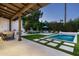 The rear exterior features a pristine pool, outdoor kitchen, covered patio and lush landscaping at 7902 E Via Linda --, Scottsdale, AZ 85258