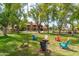 Inviting common area with colorful Adirondack chairs arranged around a cozy fire pit for community gatherings at 8700 E Mountain View Rd # 2011, Scottsdale, AZ 85258