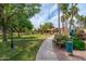 Picturesque community pathway with manicured landscaping, mature trees, and comfortable seating, offering a peaceful retreat at 8700 E Mountain View Rd # 2011, Scottsdale, AZ 85258