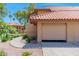 Attached two-car garage with a tile roof, offering convenience and ample parking space at 8700 E Mountain View Rd # 2011, Scottsdale, AZ 85258