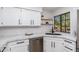Modern kitchen with white cabinets, stainless steel appliances, and a view from the window at 8700 E Mountain View Rd # 2011, Scottsdale, AZ 85258