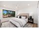 Bright main bedroom with a large window, ceiling fan, and stylish decor at 8700 E Mountain View Rd # 2011, Scottsdale, AZ 85258