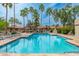 Refreshing community pool area with ample lounge seating, palm trees, and clear blue water for relaxation at 8700 E Mountain View Rd # 2011, Scottsdale, AZ 85258