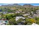 Aerial view of neighborhood, showcasing lush landscaping, mature trees, and beautiful mountain backdrop at 9829 N 49Th Pl, Paradise Valley, AZ 85253