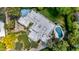Stunning aerial view of a modern home with a pool, sports court, and lush landscaping at 9829 N 49Th Pl, Paradise Valley, AZ 85253