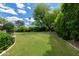 Beautiful backyard showcasing a large, well-maintained lawn and mature, lush landscaping at 9829 N 49Th Pl, Paradise Valley, AZ 85253