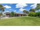 Inviting backyard showcasing a lush lawn, mature trees, swimming pool and modern home exterior at 9829 N 49Th Pl, Paradise Valley, AZ 85253