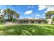 Spacious backyard with a well-manicured lawn, mature trees, and covered outdoor seating area at 9829 N 49Th Pl, Paradise Valley, AZ 85253