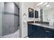 Elegant bathroom boasting blue vanity with granite countertop and tiled walk-in shower at 9829 N 49Th Pl, Paradise Valley, AZ 85253