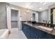 Modern bathroom featuring dual sinks with granite counters and a walk-in shower and separate tub at 9829 N 49Th Pl, Paradise Valley, AZ 85253