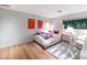 Cozy bedroom with light hardwood floors, bright natural light, and vibrant decor at 9829 N 49Th Pl, Paradise Valley, AZ 85253