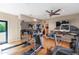 Home gym featuring mirrored wall, treadmill, and elliptical machines at 9829 N 49Th Pl, Paradise Valley, AZ 85253