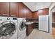 Functional laundry room equipped with modern appliances and ample storage at 9829 N 49Th Pl, Paradise Valley, AZ 85253
