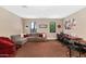 Spacious bonus room with a comfortable sectional, work space, and natural light at 9829 N 49Th Pl, Paradise Valley, AZ 85253