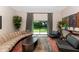 Spacious living room with a comfortable beige sofa and a beautiful view of the outdoors at 9829 N 49Th Pl, Paradise Valley, AZ 85253