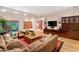Beautiful living room with sleek hardwood floors, a large sectional sofa, and modern decor at 9829 N 49Th Pl, Paradise Valley, AZ 85253
