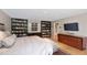 Cozy main bedroom with a wall of custom built-in bookshelves and wood flooring at 9829 N 49Th Pl, Paradise Valley, AZ 85253