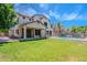Expansive backyard with lush green grass, a refreshing pool, and covered patio, perfect for outdoor entertaining at 10234 E Lomita Ave, Mesa, AZ 85209