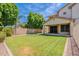 Grassy backyard offering ample space for relaxation and outdoor activities, complemented by mature landscaping and serene ambiance at 10234 E Lomita Ave, Mesa, AZ 85209