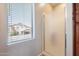Modern bathroom with glass shower door and a bright window at 10234 E Lomita Ave, Mesa, AZ 85209