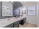 Modern bathroom features black tiled accent wall, double sinks and neutral color palette at 10234 E Lomita Ave, Mesa, AZ 85209