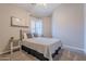 Neutral bedroom features large window and small shelves for decorations and plants at 10234 E Lomita Ave, Mesa, AZ 85209