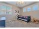 Neutral bedroom features a full size bed with trundle and built in shelves at 10234 E Lomita Ave, Mesa, AZ 85209