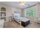 Bright bedroom with large window, built-in shelves and hanging swing chair at 10234 E Lomita Ave, Mesa, AZ 85209