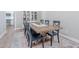 Cozy dining room featuring a rustic wood table, black chairs, and a decorative cabinet at 10234 E Lomita Ave, Mesa, AZ 85209