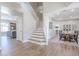 Spacious entryway with hardwood floors, staircase, and views into the living room and dining area at 10234 E Lomita Ave, Mesa, AZ 85209