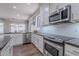 Well-lit kitchen with stainless steel appliances, white cabinets, and dark countertops at 10234 E Lomita Ave, Mesa, AZ 85209