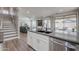 Modern kitchen island with a sink overlooking the living room at 10234 E Lomita Ave, Mesa, AZ 85209