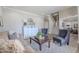 Cozy living room featuring neutral tones, a comfortable sofa, chairs, and a staircase at 10234 E Lomita Ave, Mesa, AZ 85209