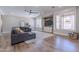 Spacious living room with a cozy sectional sofa and large windows at 10234 E Lomita Ave, Mesa, AZ 85209