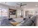 Bright living room with a large sectional and windows overlooking the backyard at 10234 E Lomita Ave, Mesa, AZ 85209