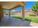 Covered patio overlooks backyard and pool with turf and fenced perimeter at 10234 E Lomita Ave, Mesa, AZ 85209