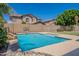 Inviting pool with Baja step, waterfall feature, and mature landscaping, perfect for leisure and recreation at 10234 E Lomita Ave, Mesa, AZ 85209