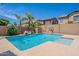 Sparkling blue pool with waterfall feature and basketball hoop, offering a refreshing oasis in the backyard at 10234 E Lomita Ave, Mesa, AZ 85209